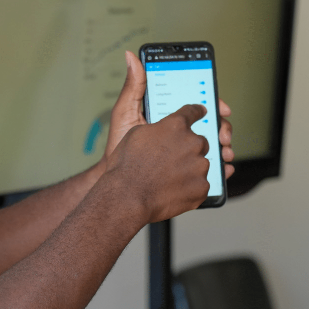 bachelor of computing student showing his app on a phone