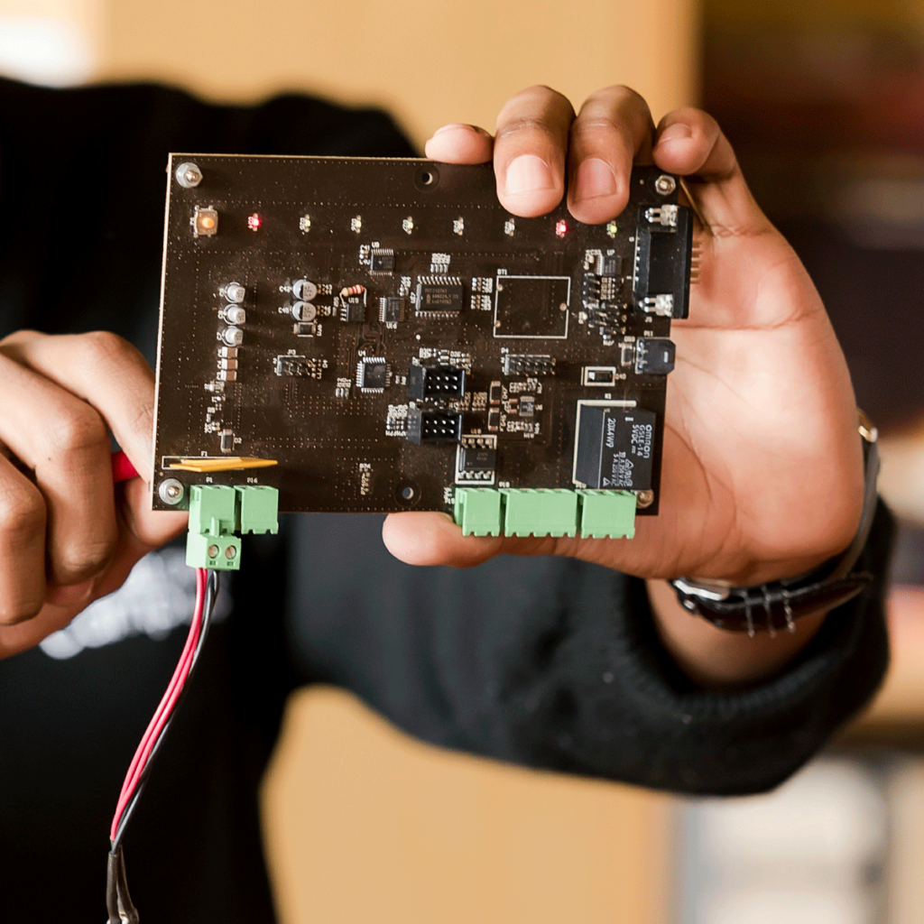 bachelor of computing student holding a arduino